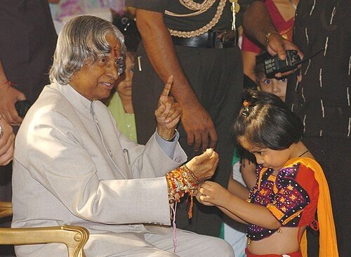 India President receiving rakhi from young girl