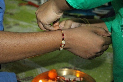 tying the bond of Raksha Bandhan